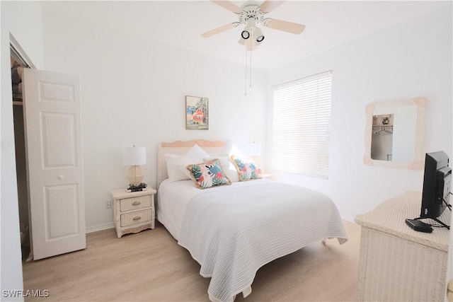 bedroom with baseboards, ceiling fan, and light wood finished floors