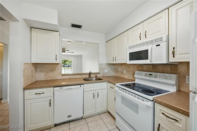 kitchen featuring visible vents, a sink, white cabinetry, white appliances, and light tile patterned flooring