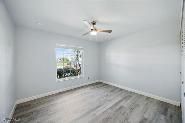 unfurnished room featuring baseboards, wood finished floors, and a ceiling fan