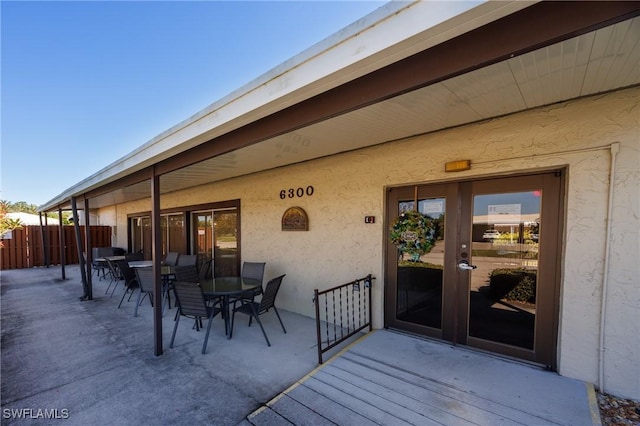 wooden terrace featuring outdoor dining area and fence