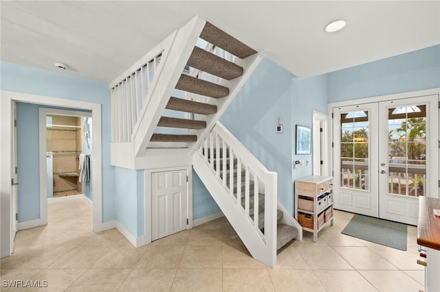 stairs with tile patterned flooring, french doors, and baseboards