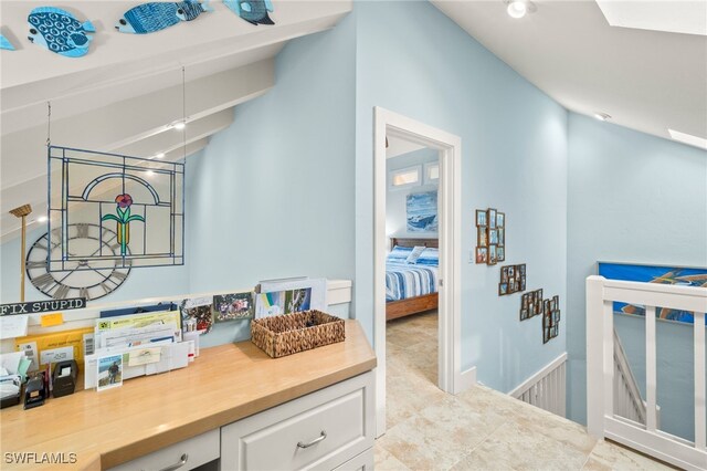 bathroom with lofted ceiling with skylight and vanity