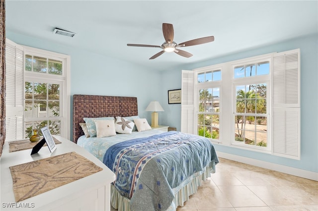 bedroom featuring light tile patterned floors, visible vents, and ceiling fan