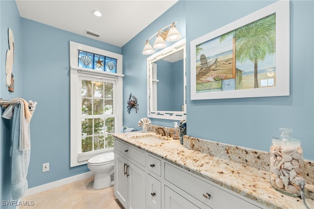 bathroom featuring visible vents, toilet, tile patterned flooring, baseboards, and vanity