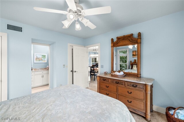 bedroom featuring visible vents, ensuite bathroom, and a ceiling fan