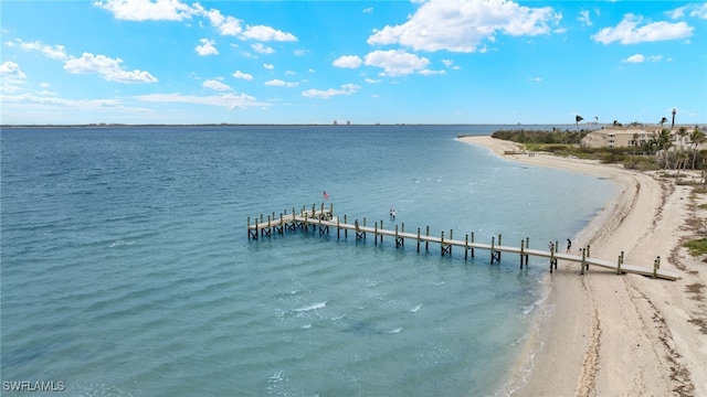 view of dock with a view of the beach and a water view