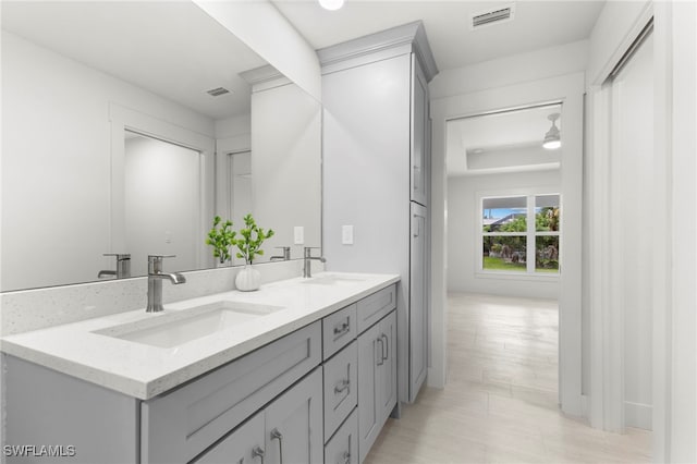 bathroom with a sink, visible vents, and double vanity