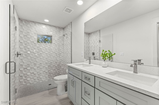 bathroom with visible vents, a stall shower, and a sink