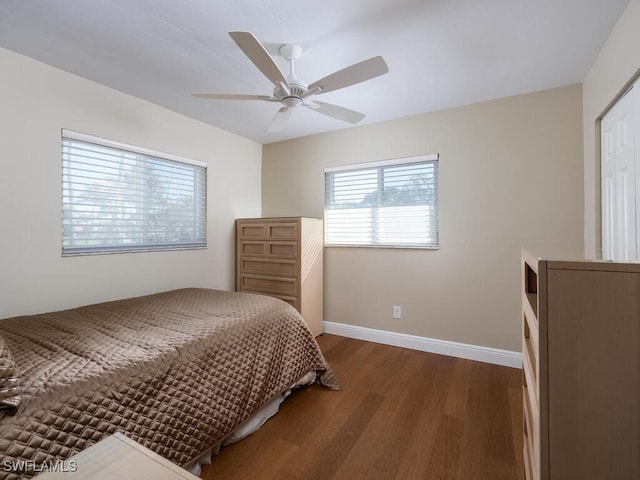 bedroom with ceiling fan, baseboards, and wood finished floors