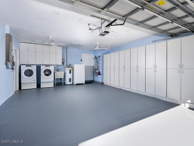 garage featuring ceiling fan, washing machine and dryer, water heater, a garage door opener, and a sink