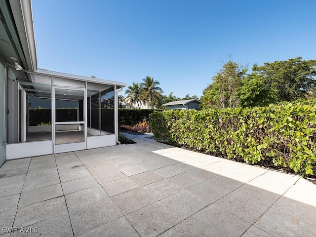 view of patio / terrace featuring a sunroom