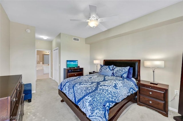 bedroom with a ceiling fan, visible vents, a closet, light colored carpet, and connected bathroom