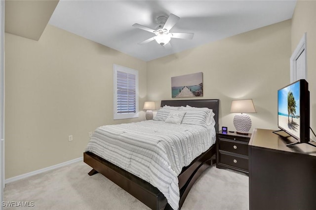 bedroom with a ceiling fan, light colored carpet, and baseboards