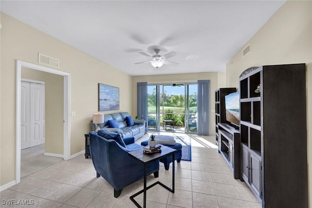 living area featuring ceiling fan, baseboards, and light tile patterned flooring