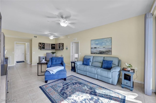 living area with light tile patterned flooring, baseboards, and visible vents