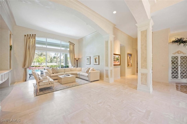 living area with arched walkways, recessed lighting, ornate columns, and ornamental molding