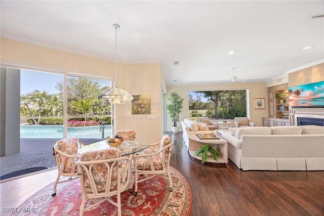 dining space featuring hardwood / wood-style flooring, a wealth of natural light, and ornamental molding