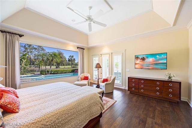 bedroom with a raised ceiling, access to exterior, dark wood-style flooring, and ornamental molding