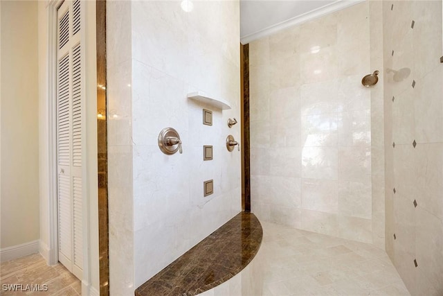 full bathroom featuring a closet, a heating unit, and tiled shower