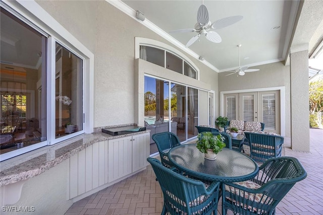 sunroom with plenty of natural light and a ceiling fan