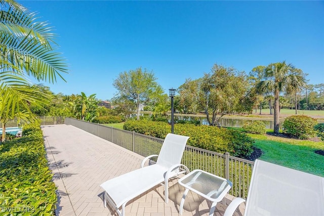 view of community with a patio and fence