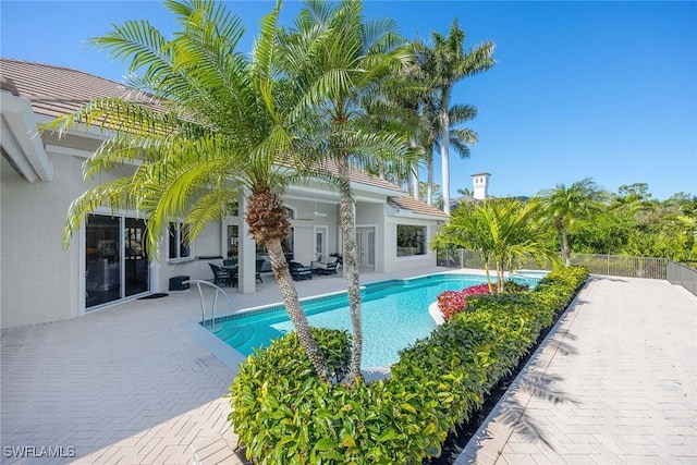 view of swimming pool featuring a fenced in pool, a patio, and fence