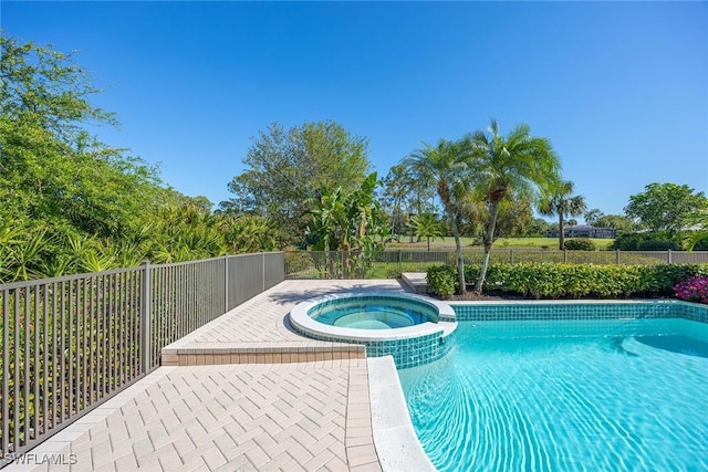 view of pool with a pool with connected hot tub and fence