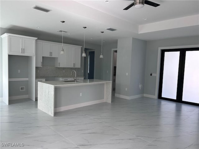 kitchen with a large island, visible vents, marble finish floor, and a sink