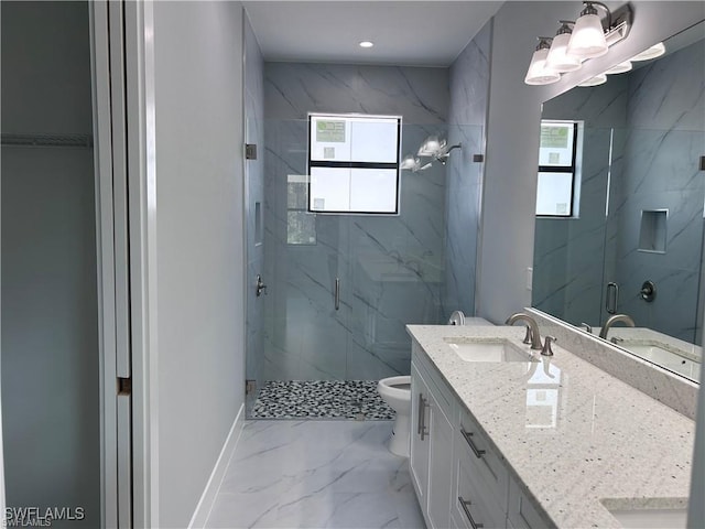 full bath with plenty of natural light, marble finish floor, and a sink