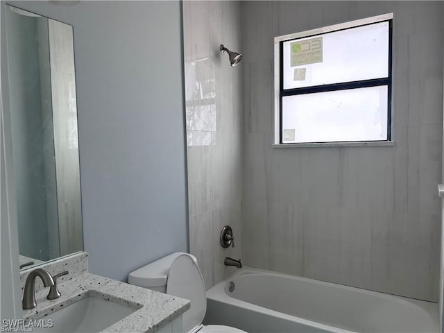 bathroom with vanity, toilet, and shower / bath combination