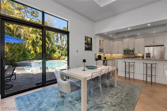 dining room featuring recessed lighting, light tile patterned flooring, and crown molding