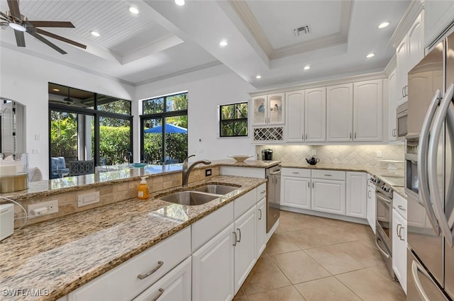 kitchen featuring a raised ceiling, visible vents, stainless steel appliances, and a sink