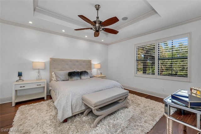 bedroom featuring baseboards, a raised ceiling, and ornamental molding