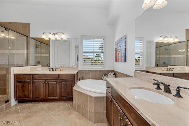 bathroom with a sink, a garden tub, a stall shower, and tile patterned flooring