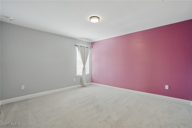 carpeted empty room with baseboards