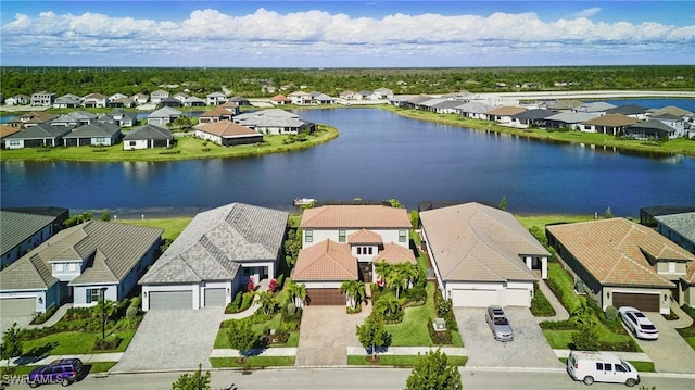 drone / aerial view with a residential view and a water view