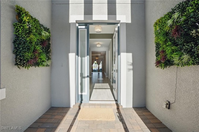 entrance to property with stucco siding