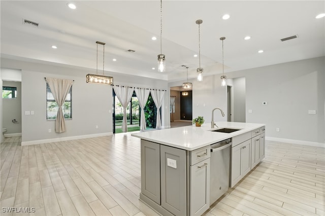 kitchen featuring visible vents, light countertops, recessed lighting, stainless steel dishwasher, and a sink