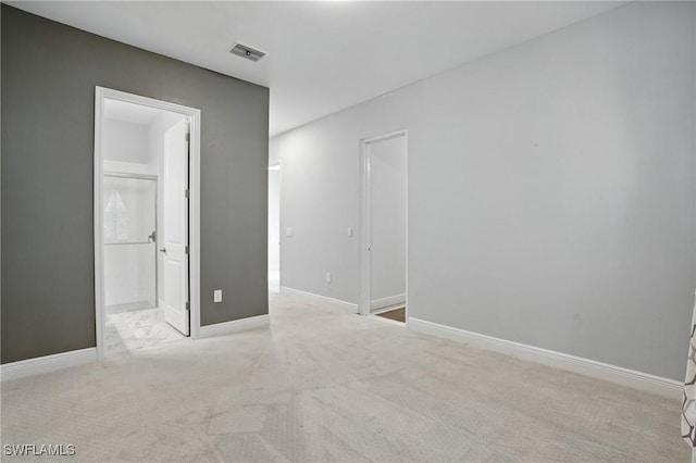 unfurnished room with visible vents, carpet flooring, and baseboards