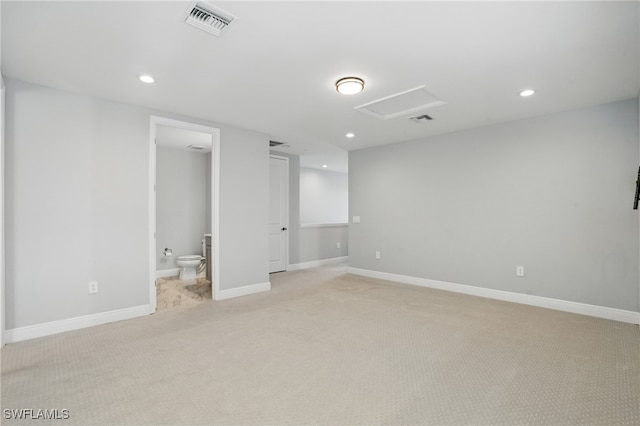 empty room featuring recessed lighting, visible vents, light colored carpet, and baseboards