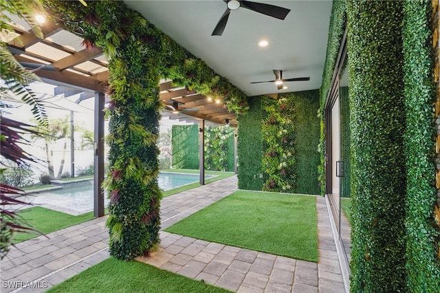 view of yard with a patio area, an outdoor pool, and ceiling fan