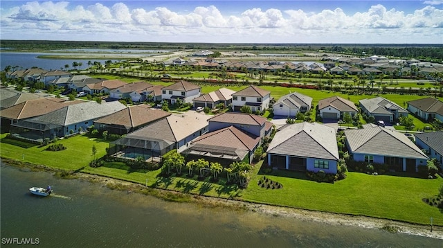 drone / aerial view featuring a residential view and a water view