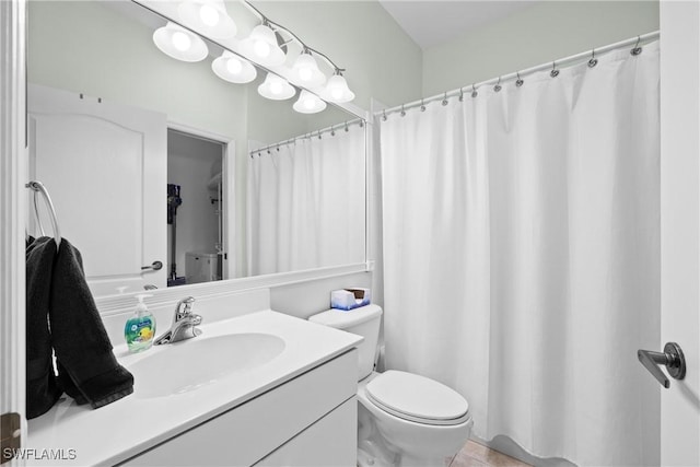 bathroom with vanity, toilet, and tile patterned flooring