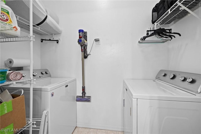 washroom with laundry area, light tile patterned flooring, and washing machine and dryer