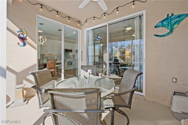 view of patio with outdoor dining space and a ceiling fan