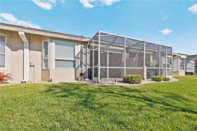 back of house featuring stucco siding, a lawn, and glass enclosure