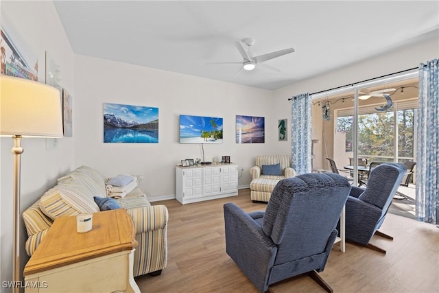 living area with ceiling fan, baseboards, and wood finished floors