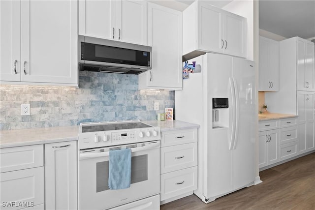 kitchen with white appliances, wood finished floors, light countertops, white cabinetry, and tasteful backsplash