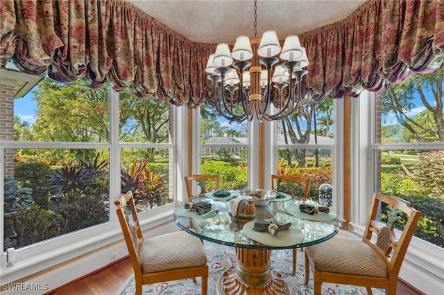 sunroom featuring an inviting chandelier