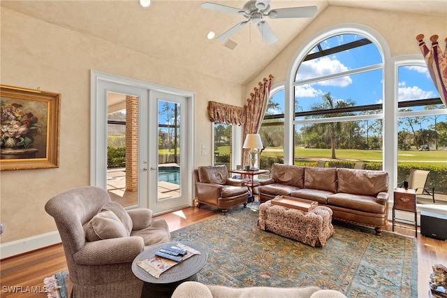 sunroom / solarium featuring visible vents, a ceiling fan, and vaulted ceiling